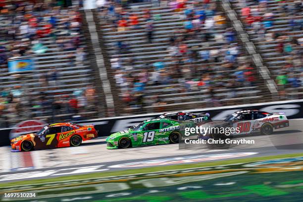 Justin Allgaier, driver of the Reese's Ice Cream/Sam's Club Chevrolet, leads Trevor Bayne, driver of the Interstate Batteries Toyota, and Cole...