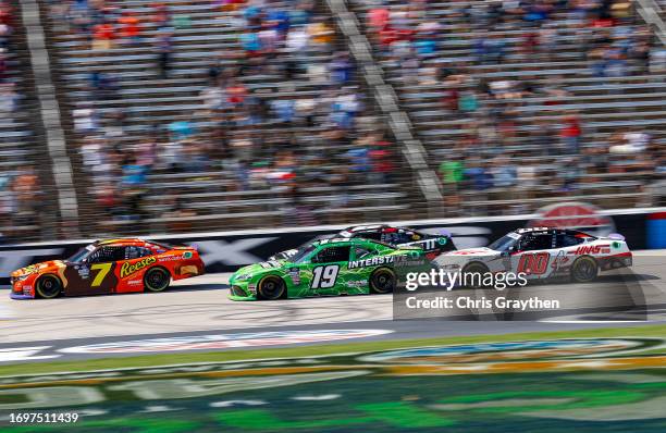 Justin Allgaier, driver of the Reese's Ice Cream/Sam's Club Chevrolet, leads Trevor Bayne, driver of the Interstate Batteries Toyota, and Cole...