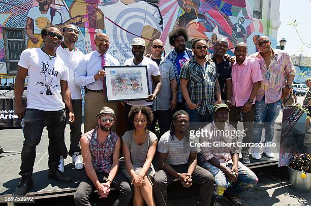 Philadelphia Mayor Michael Nutter poses with Questlove, Black Thought, The Roots and artists of The Roots Mural attend The Roots Mural Dedication at...