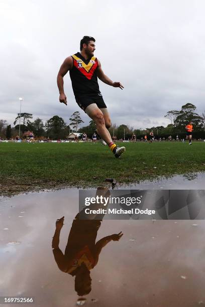 Brendan Fevola of Bacchus Marsh looks ahead after kicking the ball for a goal attempt during the round six BFL match between Bacchus Marsh and...