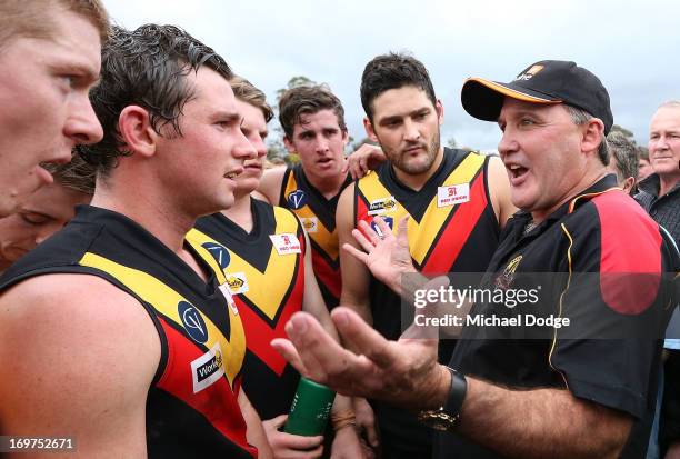 Brendan Fevola of Bacchus Marsh listens to coach and Western Bulldogs legend Doug Hawkins speak in a quarter time huddle during the round six BFL...