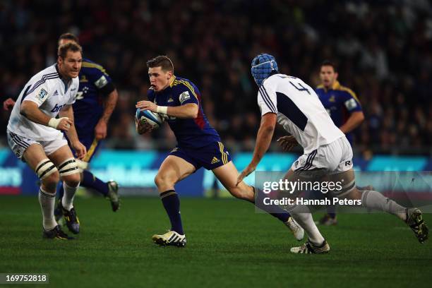 Colin Slade of the Highlanders makes a break during the round 16 Super Rugby match between the Highlanders and the Blues at Forsyth Barr Stadium on...