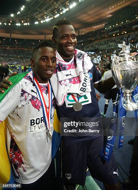 Andre Biyogo Poko and Cheick Diabate of Bordeaux, holding the trophy, celebrate their 3-2 victory after the French Cup Final match between FC...