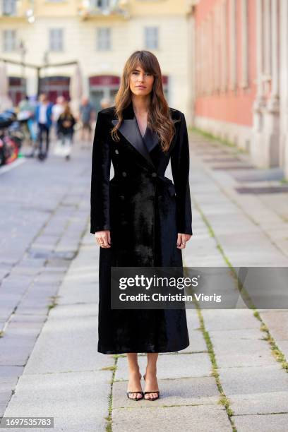 Alison Toby wears black tailored coat, heels outside Ermanno Scervino during the Milan Fashion Week - Womenswear Spring/Summer 2024 on September 23,...