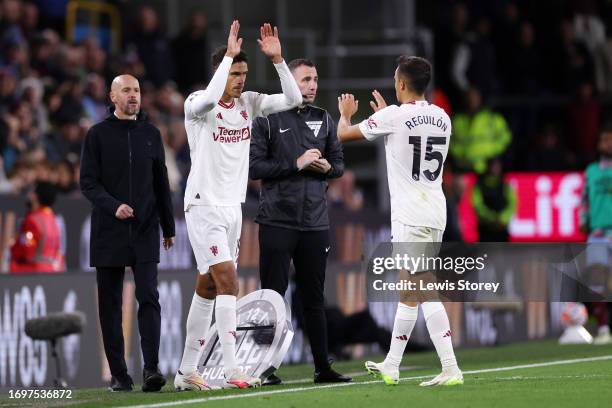 Sergio Reguilon of Manchester United interacts with Raphael Varane of Manchester United after being substituted off during the Premier League match...