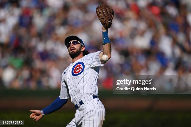 Dansby Swanson of the Chicago Cubs is unable to catch a fly ball in the seventh inning against the Colorado Rockies at Wrigley Field on September 23,...