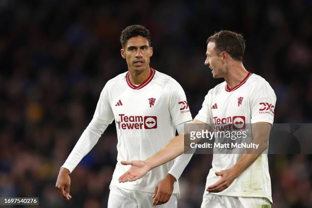 Raphael Varane and Jonny Evans of Manchester United interact during the Premier League match between Burnley FC and Manchester United at Turf Moor on...