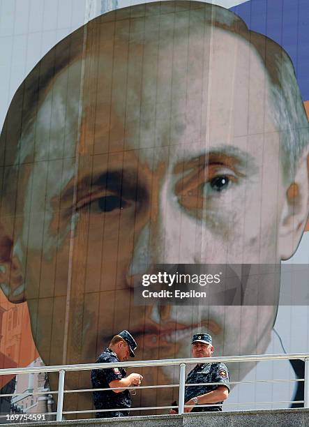 Chechen police in front of a portrait of Russian President Vladimir Putin before the Russian Cup Final match between FC Anji Makhachkala and PFC CSKA...