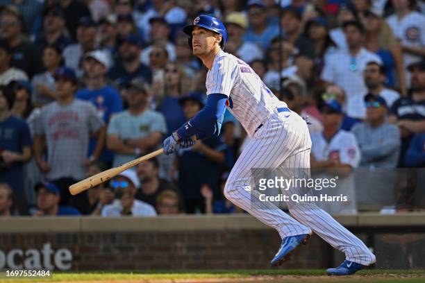 Cody Bellinger of the Chicago Cubs follows his RBI sacrifice fly in the seventh inning against the Colorado Rockies at Wrigley Field on September 23,...
