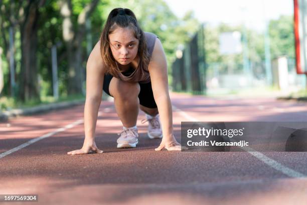 young woman with down syndrome exercise - down syndrome stock pictures, royalty-free photos & images