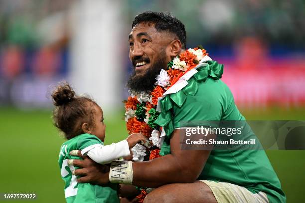 Bundee Aki of Ireland celebrates victory with a child on the pitch during the Rugby World Cup France 2023 match between South Africa and Ireland at...