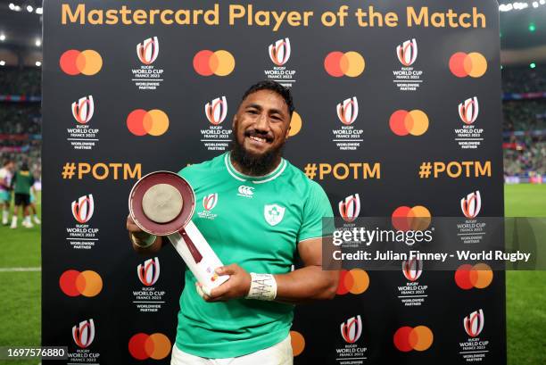 Bundee Aki of Ireland , the MASTERCARD Player of the Match, poses for a photograph with a Trophy after the Rugby World Cup France 2023 match between...