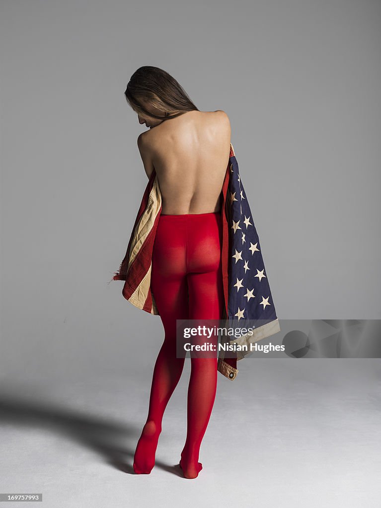 Woman wrapped in american flag showing Patriotism