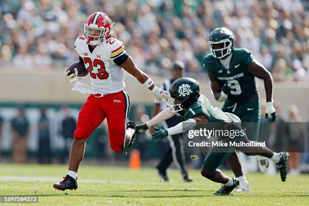 Colby McDonald of the Maryland Terrapins runs past Jaden Mangham of the Michigan State Spartans in the second quarter of a game at Spartan Stadium on...