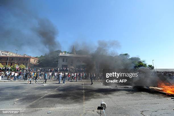 Smokes rises as Turkish protestors and riot policemen clash on June 1 during a protest against the demolition of Taksim Gezi Park, in Taksim Square...