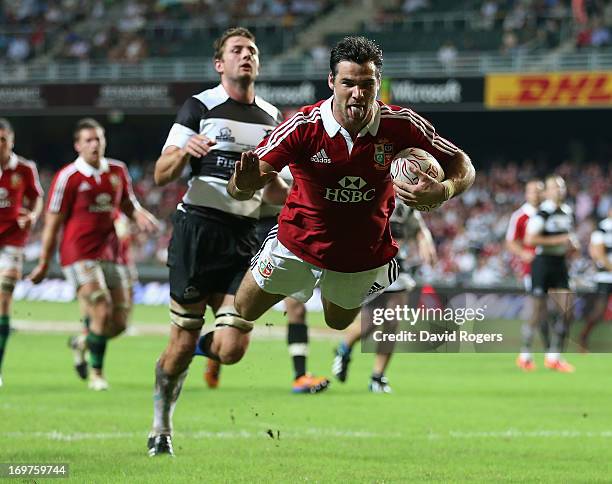 Mike Phillips of the Lions dives to score his second try during the match between the British & Irish Lions and the Barbarians at Hong Kong Stadium...