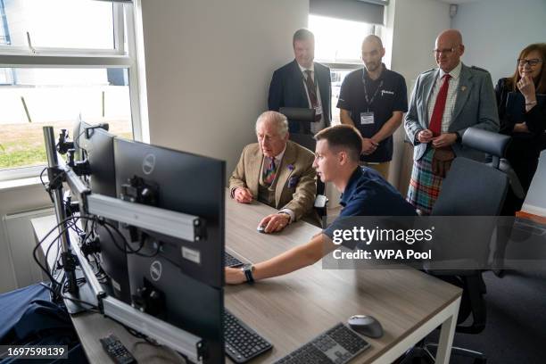 King Charles III operates a underwater ROV as he visits the Global Underwater Hub on September 29, 2023 in Aberdeen, Scotland.