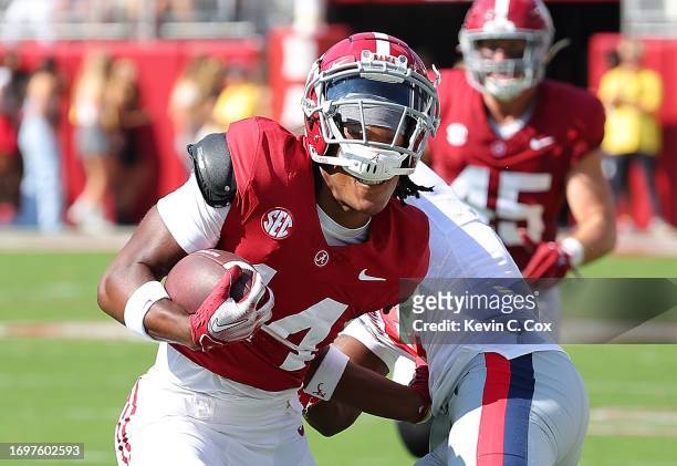 Jalen Hale of the Alabama Crimson Tide pulls in this reception as he tackled by Zamari Walton of the Mississippi Rebels during the second quarter at...