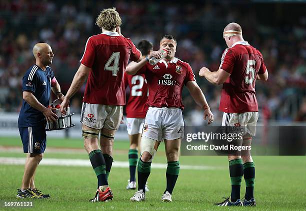 Cian Healy , Paul O'Connell and Richie Gray take on liquid during a rehydration break during the match between the British & Irish Lions and the...