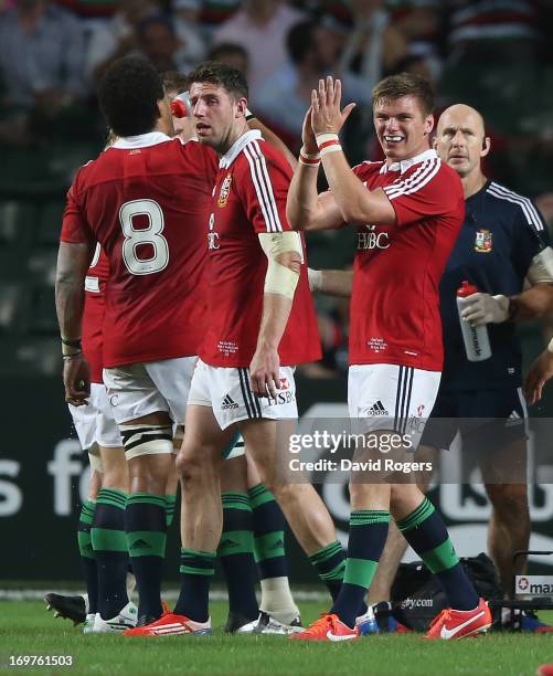 Owen Farrell of the Lions applauds the referee, Steve Walsh after showing the yellow card to Barbarian hooker, Schalk Brits during the match between...