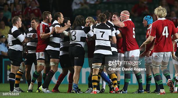 Fight breaks out between the two teams after Schalk Brits of the Barbarians strikes Owen Farrell during the match between the British & Irish Lions...