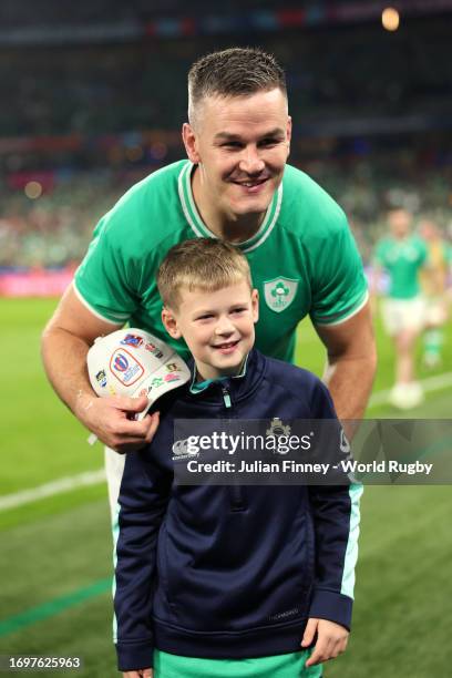 Johnny Sexton of Ireland celebrates victory on the pitch with a child after defeating South Africa during the Rugby World Cup France 2023 match...