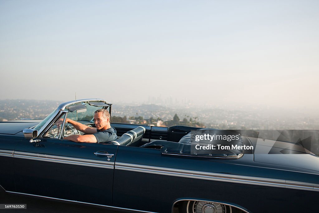 Man driving convertible car