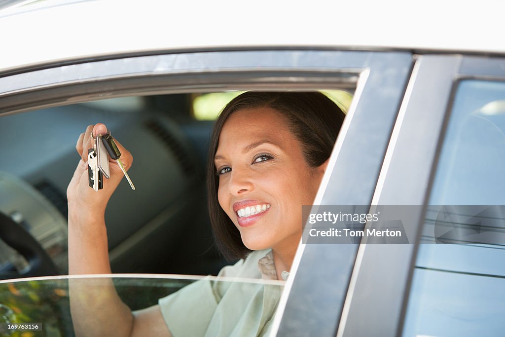 Woman holding keys to new car