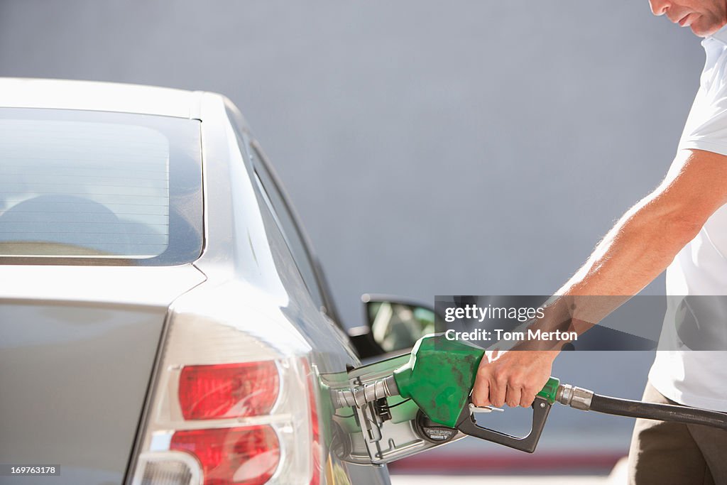 Man filling car with gas