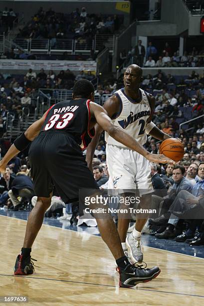 Guard Michael Jordan of the Washington Wizards looks to play the ball as guard Scottie Pippen of the Portland Trail Blazers defends during the game...
