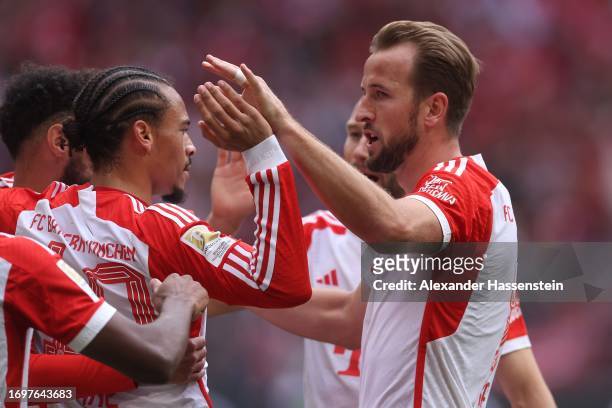 Leroy Sane of FC Bayern München celebrates scoring the 4rd team goal with his team mate Harry Kane during the Bundesliga match between FC Bayern...