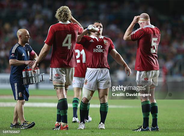 Cian Healy , Paul O'Connell and Richie Gray take on liquid during a rehydration break during the match between the British & Irish Lions and the...