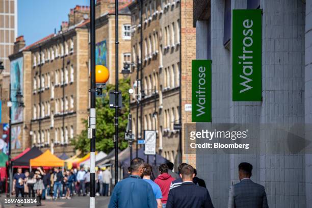 Signs outside a Waitrose supermarket in London, UK, on Friday Sept. 29, 2023. John Lewis Partnership Plc is planning to raise as much as £150 million...