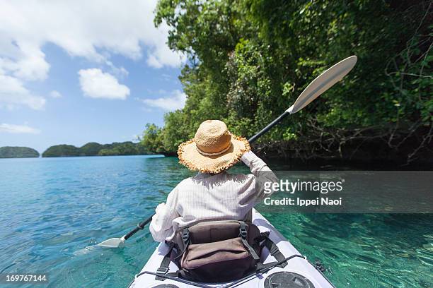 tropical rock island lagoon kayaking, palau - palau stockfoto's en -beelden