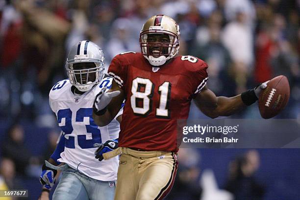 Wide receiver Terrell Owens of the San Francisco 49ers celebrates in the end zone after catching the game winning touchdown against the Dallas...