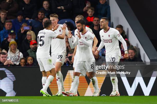 Bruno Fernandes of Manchester United celebrates with teammates after scoring the teams first goal during the Premier League match between Burnley FC...