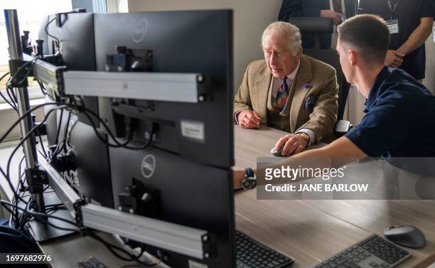 Britain's King Charles III operates an underwater ROV during his visit to the Global Underwater Hub in Westhill, eastern Scotland, September 29 where...
