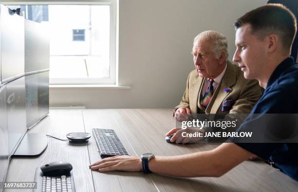 Britain's King Charles III operates an underwater ROV during his visit to the Global Underwater Hub in Westhill, eastern Scotland, September 29 where...