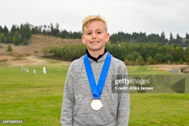 Regional qualifier Emery Johnson, winner of the boys 10-11 division, smiles during the 2023 Drive, Chip and Putt Regional Qualifier at Chambers Bay...