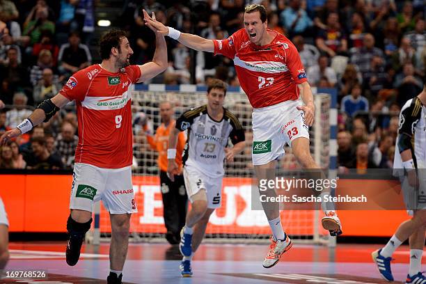 Pascal Hens and Igor Vori of Hamburg celebrate during the EHF Final Four match between THW Kiel and HSV Hamburg at Lanxess Arena on June 1, 2013 in...