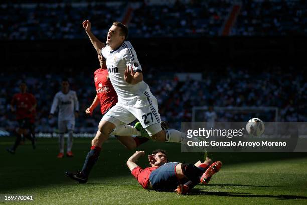 Nacho Fernandez of Real Madrid CF is challenged by Unai Garcia of CA Osasuna during the La Liga match between Real Madrid CF and CA Osasuna at...
