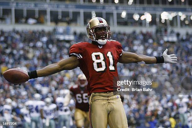 Wide receiver Terrell Owens of the San Francisco 49ers celebrates in the end zone after scoring a touchdown against the Dallas Cowboys with 12...