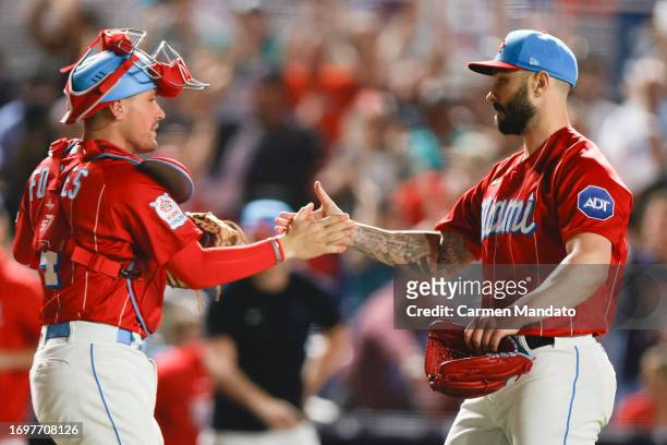 Tanner Scott and Nick Fortes of the Miami Marlins high five after defeating the Milwaukee Brewers 5-4 at loanDepot park on September 23, 2023 in...