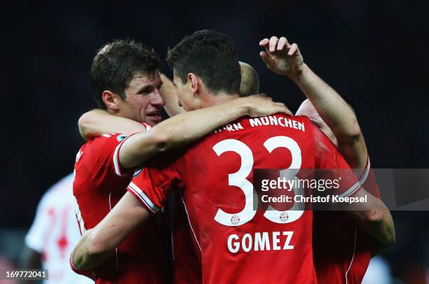 Mario Gomez of Bayern Muenchen celebrates with Thomas Mueller as he scores their third goal during the DFB Cup Final match between FC Bayern Muenchen...