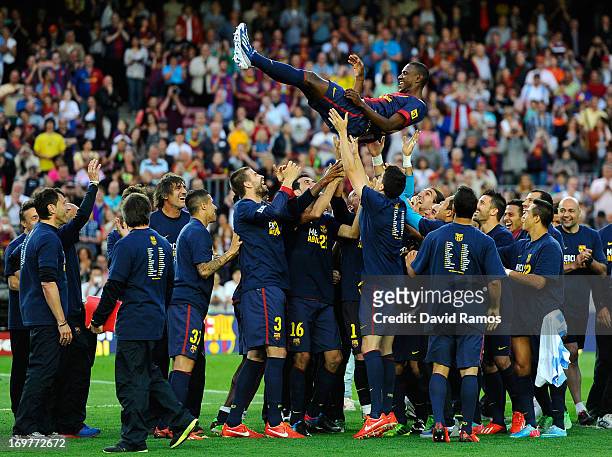 Barcelona players throw their team-mate Eric Abidal into the air after he played his last match with FC Barcelona at the end of the La Liga match...