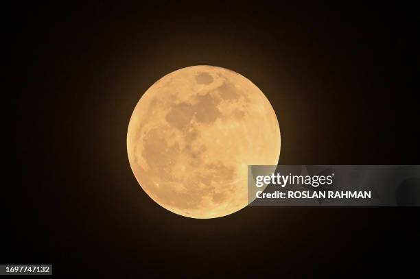 The full moon, a supermoon also known as the "Harvest Moon", rises over Singapore on September 29, 2023.