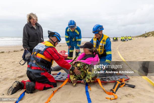 Coastguard Search and Rescue members taking part in a South East Coast Ambulance Service organised simulated emergency situation on Camber Sands on...
