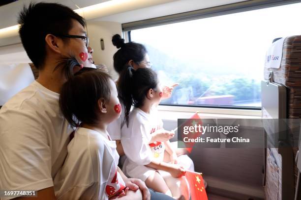 Passengers on a bullet train on the first day of operation of the 350km/h Fuzhou-Xiamen highspeed railway in Quanzhou in southeast China's Fujian...