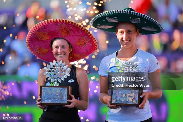 Storm Hunter of Australia and Elise Mertens of Belgium celebrate with the champion trophies after winning the women's doubles final match against...