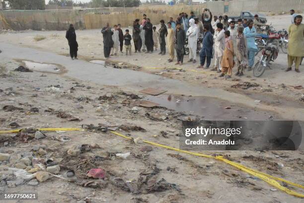 People inspect the site of the bomb blast at a mosque in Mastung town in the Balochistan province of Pakistan on September 29, 2023. At least 50...